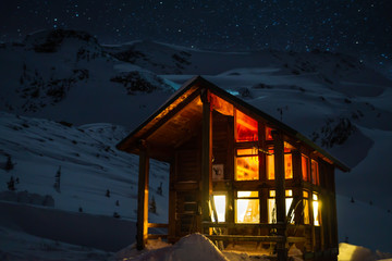 Backcountry hut, lit up at night in the Asulkan Valley of Rogers Pass