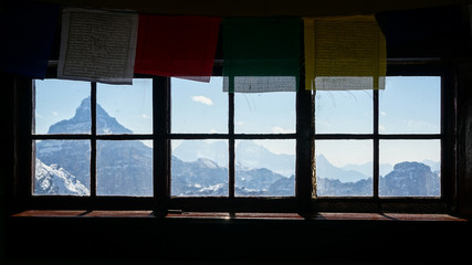 Fototapeta premium Prayer flags above a window in a climbing hut in the Canadian Rockies