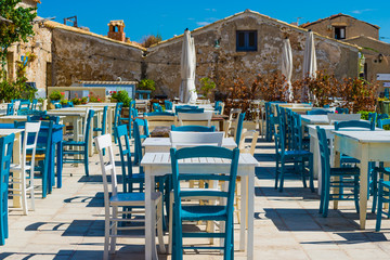 Detail of a characteristic and rustic restaurant in a tourist resort during a summer day. Useful for use as a backdrop for advertising in summer vacation resorts. Marzamemi