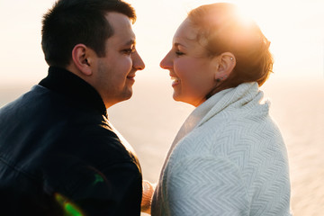 couple in love look at each other and smile on them the sun's ra