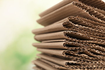 Stack of cardboard for recycling on blurred background, closeup