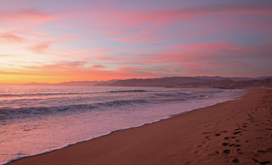 Fototapeta na wymiar Pink sunset cloud reflection over Santa Clara river seaside marsh at Ventura beach in California United States