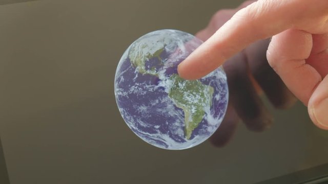 Reflection of a caucasian pointing at the earth on a screen themes of astronomy science earth space - Created with public domain images from Nasa