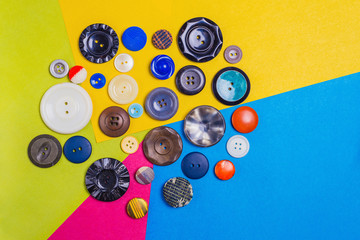 Small lot of vintage buttons lying on a colorful, fun background.