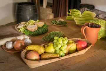 Various fruits and vegetables lying on an old wooden table