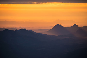 Fototapeta na wymiar Wonderful landscape sunrise mountain with fog mist yellow gold sky and rising sunshine in the morning on hill