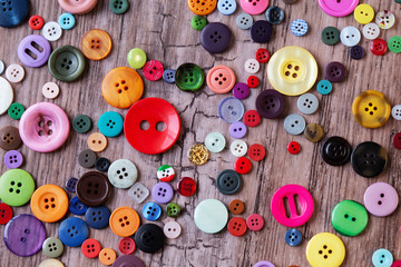 colorful assorted sewing buttons on a table. vintage buttons on a wooden background