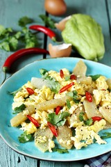 egg chayote in mexican style. whipped eggs are fried with chopped chayote with cilantro and spicy chili. recipe with chayote. top view. Mexican food