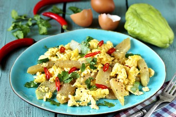 egg chayote in mexican style. whipped eggs are fried with chopped chayote with cilantro and spicy...