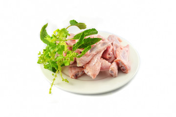 Fresh raw chicken wing on plate and holy basil isolated on white background
