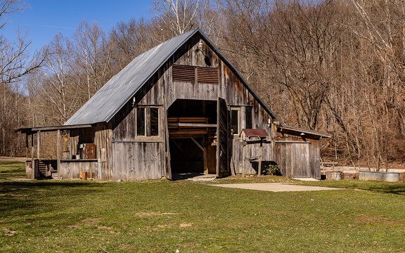 An old wooden barn on beautiful winter day. 
