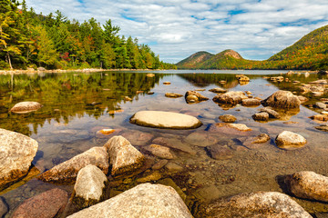 Jordan Pond in Acadia Nantional Park, Maine with calm and transparent waters, on a sunny autumn day.