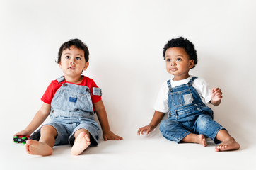 Two little boys sitting studio shot