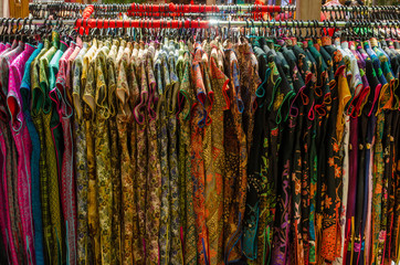 Colorful chinese cheongsam hanging for sale during Chinese New Year.