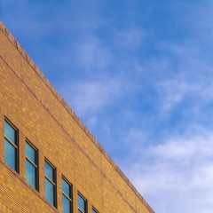 Building with rectangular windows against blue sky