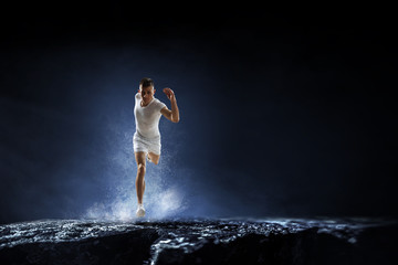 Obraz na płótnie Canvas Sportsman running race. Mixed media