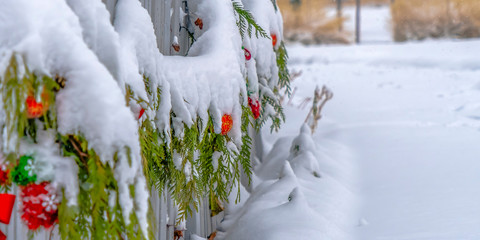 Christmas garland draped on a fence in winter