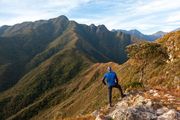 Unrecognized people enjoying the mountain landscape view from a mountain