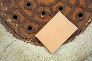 notebook on rusty manhole
