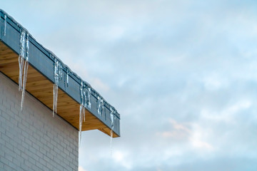 Icicles on a roof in Eagle Mountain against sky