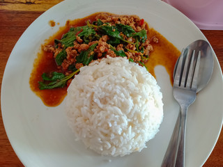 Top view of Stir fried minced pork with basil served and steamed jasmin rice, Thai spicy food