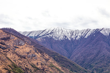 Snow on top of high mountain with white cloud near Como lake , Italy