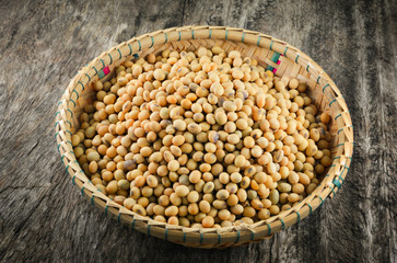 soybeans or soya beans grain seed on bamboo basket on rustic wood background