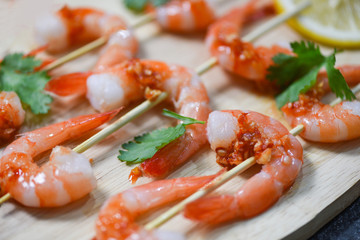 Seafood plate with shrimps prawns skewers seafood cooked with sauce herbs and spices