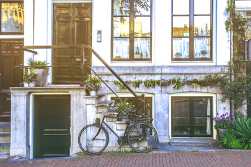 Bicycle park  in front of stairs to entrance doors of tradition building in Amsterdam, Netherlands