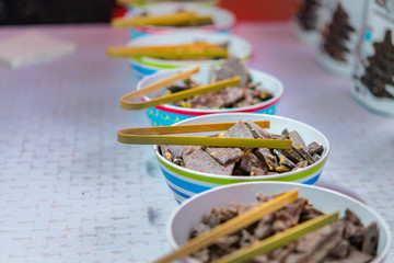 Choclate pieces with tongs