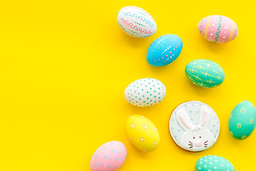 Fototapeta na wymiar Easter symbols. Colorful Easter eggs and gingerbread on yellow background space for text