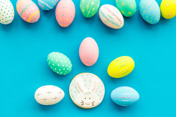 Easter symbols. Colorful Easter eggs and gingerbread on blue background space for text