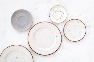 Ceramic plates pattern on white background top view