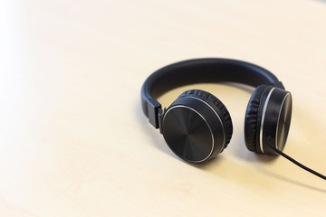 Obraz na płótnie Canvas Black headphones on wooden table background