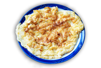 Scrambled eggs on plate over white stone background. Top view, flat lay