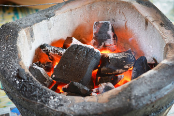 Charcoal burning fires in stove for barbecue grill