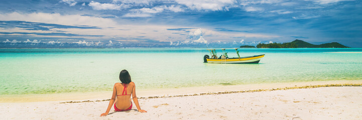 Luxury paradise getaway beach in French Polynesia. Secluded island boat tour in Tahiti, woman...