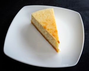 milk cake sweet food / piece of dessert delicious top view vanilla cake slice on white plate
