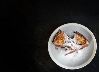 brownies cake on the table / piece of chocolate cake cocoa with nut and icing sugar on top view brownies slice
