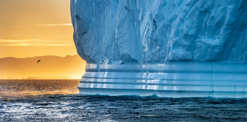 Iceberg at sunset. Nature and landscapes of Greenland. Disko bay. West Greenland. - obrazy, fototapety, plakaty