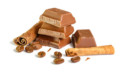 Tasty milk chocolate closeup with grains of coffee and cinnamon sticks isolated on white background