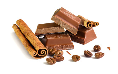 Tasty milk chocolate closeup with grains of coffee and cinnamon sticks isolated on white background