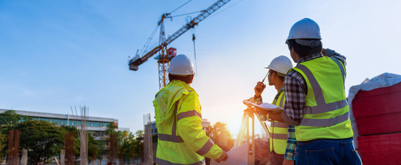 Construction engineers discussion with architects at construction site or building site of highrise building with Surveying for making contour plans is a graphical representation of the lay in land.