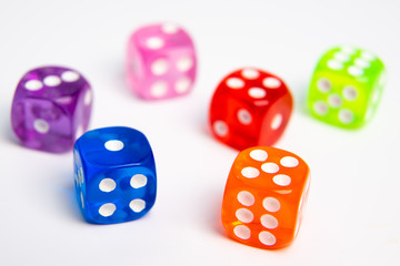 Dice of different colors isolated on a white background.