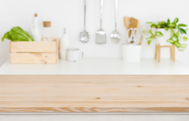 Blurred kitchen workplace with empty wooden table top in front