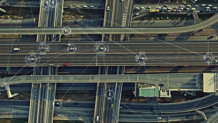 Aerial view from above of traffic on the elevated expressway with futuristic autonomous, driverless...
