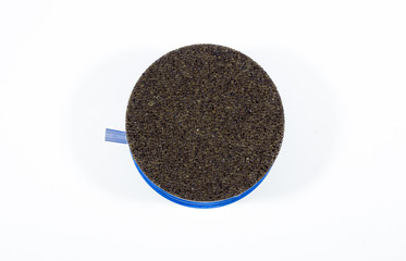 Black caviar in a bowl on a white background. High price