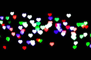 Multicolored bokeh on black background. Heart shape. Love Concept, Valentine's Day. Can be used as a background or wallpaper