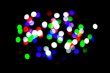 Multicolored bokeh on black background. Can be used as a background or wallpaper