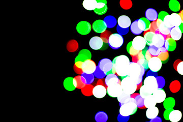 Multicolored bokeh on black background. Can be used as a background or wallpaper